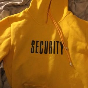 A yellow security hoodie